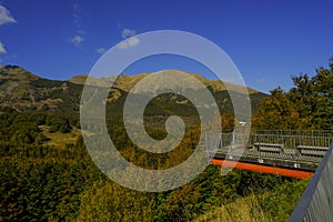 Mountains landscape across blue sky annd a bridge with binocular across the scenic view. Mountains background. Parco Nazionale del photo