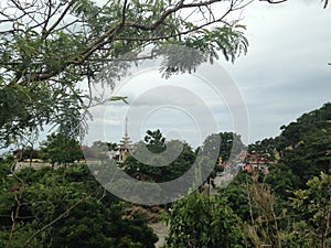 Mountains landscape, buddhists temple, seaside, blue sky, tropicaal trees.