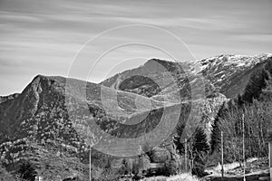 Mountains with little snow on the top in the fjord in Norway in black and white