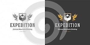 Mountains logo emblem outdoor adventure expedition vector illustration mountain and flying eagle silhouettes