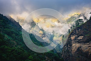 Mountains in low clouds in overcast evening in Nepal