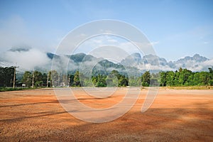 Mountains with morning fog and red soil