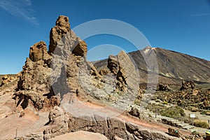 Mountains near volcano Teide, partly covered by the clouds. Bright blue sky. Teide National Park, Tenerife, Canary Islands, Spain