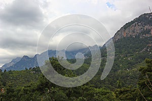 Mountains near which thickened gloomy clouds photo