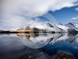 Mountains and night sky, Lofoten islands, Norway. Reflection on the water surface. Winter landscape with night sky. Long exposure