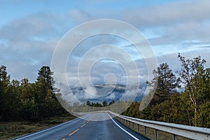 Mountains in Norway road epic scenic sky, way, clouds view. Traveling by car, driving nature tourism