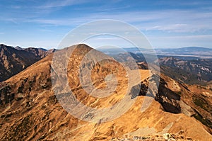 Mountains peaks on blue sky.