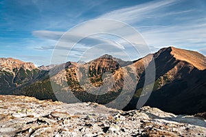 Mountains peaks on blue sky.