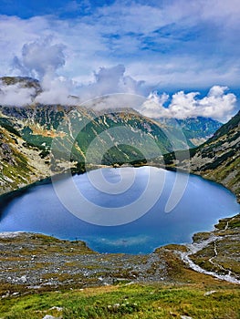 Mountains, peaks, lake, everlasting ice and trees landscape. Mountain lake. A secluded lake in a beautiful alpine paradise. Lake