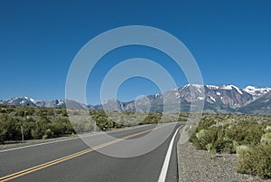 Mountains range with snow peaks and road