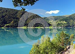 Mountains Reflecting In The Beautiful Turquoise Water Of The Lustrafjord