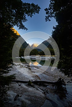 Mountains reflecting in Clinton river, Milford track, New Zealand