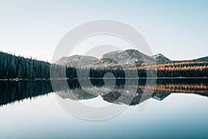 Mountains reflecting in Mirror Lake, in the Uinta Mountains, Utah photo