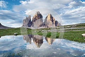 Mountains reflection on the water surface. Natural landscape in the Dolomites Alps in the Italy.