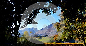 Mountains relief under the blue sky with autumn vegetation.