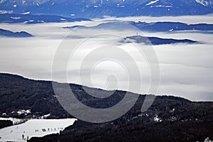 Mountains rising over clouds