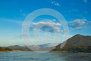 Mountains and River with a white cloud and blue sky background
