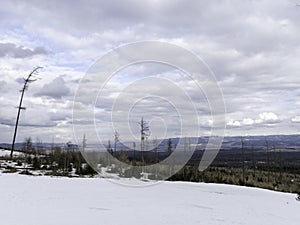 Mountains and rocks covered with snow, overcast winter day,