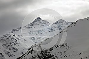 Mountains in snow in cloudy weather