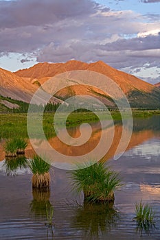 Mountains in sunset light and reflections in the lake.