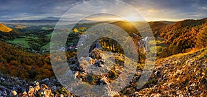 Mountains at sunset in Slovakia - Vrsatec. Landscape with orange trees in fall, colorful sky with golden sunbeams. Panorama