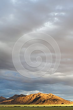 Mountains at sunset under a cloudy sky