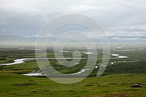 The mountains are surrounded by clouds and the wetlands after the rain photo