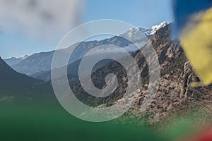 Mountains surrounding Upper Pisang through buddhist prayer flags