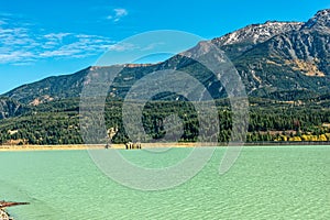 Mountains tower over Lajoie Dam on Downton Lake near Gold Bridge in British Columbia, Canada