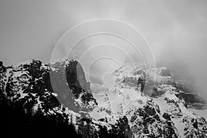 Mountains trying to pierce the heavy fog in the Alps