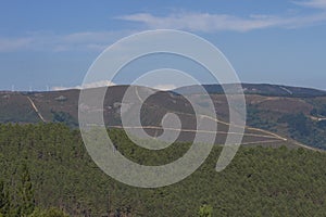 Mountains under a blue sky with large tracks