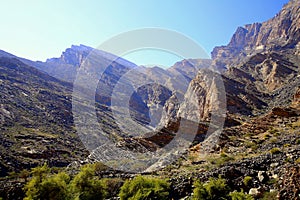 Mountains with unidirectional rocks fractures and grass area, Wadi Bani Awf, Al Rustaq, South Batinah Governorate of Oman