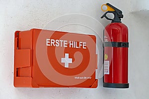 First aid box and fire extinguisher on wall