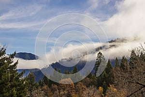 Mountians enveloped with misty fog on an autumn day