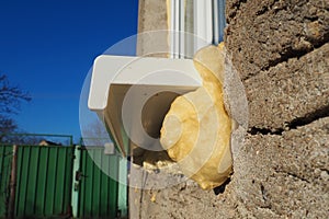 Mounting foam under the window sill.DIY concept. Construction PU - poly urethane foam. The window is installed using a photo