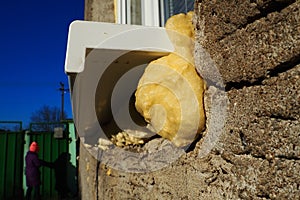 Mounting foam under the window sill.DIY concept. Construction PU - poly urethane foam. The window is installed using a photo