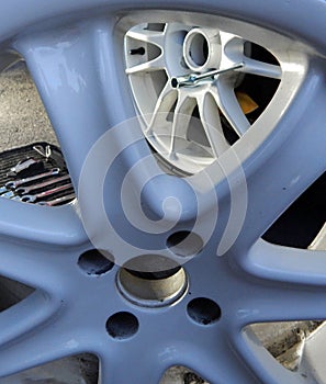 Mounting of new wheel rim through damaged dismantled wheel disk vertical stock photo