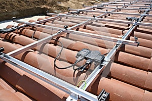 Mounting rails and electrical cables before installation of solar panels  on roof photo