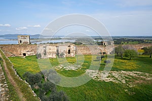 Mourao castle towers and wall historic building with interior garden with alqueva dam reservoir in Alentejo, Portugal