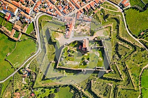 Mourao drone aerial top view of star shapped castle with alqueva dam lake behind in Alentejo, Portugal