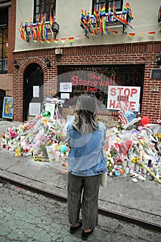 Mourner honors Orlando massacre victims at the gay rights landmark Stonewall Inn