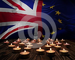 Mourning candles burning on Union Jack And European Union flags background. Memorial weekend, patriot veterans day, National Day