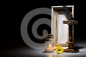 Mourning frame with crucifix, flower and candle