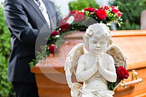 Mourning man at Funeral with coffin