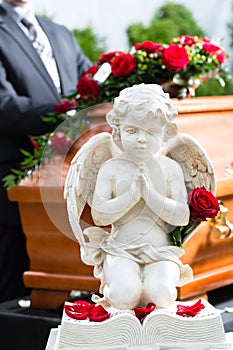 Mourning man at Funeral with coffin