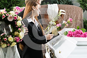 Mourning People at Funeral with coffin photo