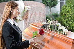 Mourning Woman at Funeral with coffin photo