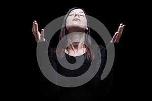 Mourning woman praying, with arms outstretched in worship to god