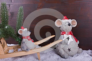 Mouse and baby mouse on a wheelbarrow with fir trees