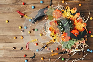 Mouse, candy, bats, pumpkin on hay on rustic background, autumn, Halloween